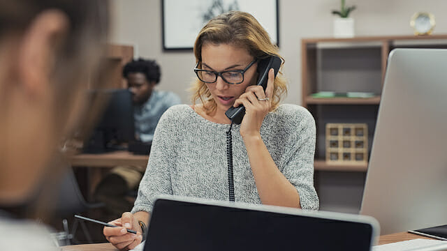 Woman on phone at desk