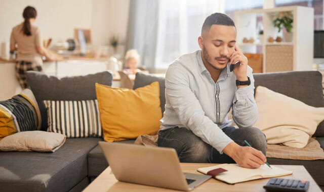 man working at coffee table